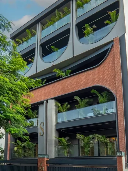 This image shows the transition from a 3D concept to the final built form. Every curve and material detail of this modern facade in Delhi comes alive on site, reflecting our precision in execution.