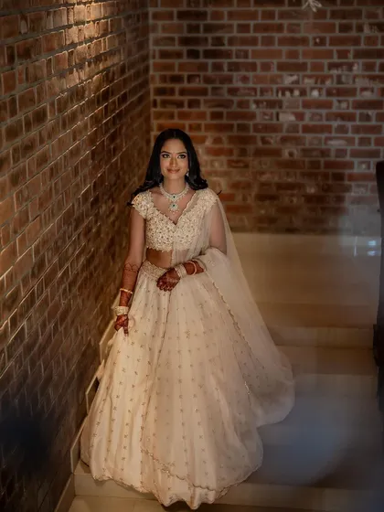 A full-length shot of her on the stairs, her lehenga flowing beautifully.