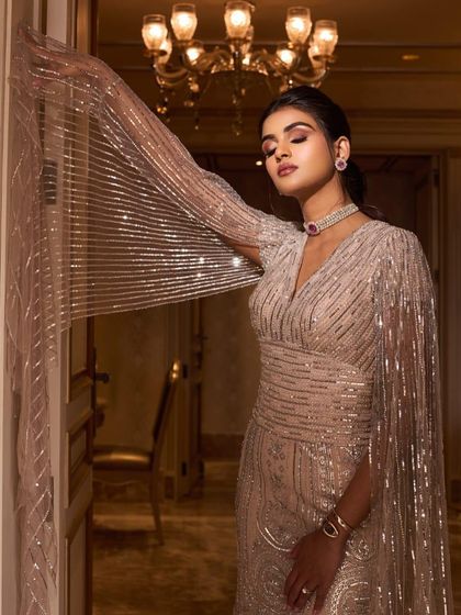 A final, artistic shot of the engagement look. The soft lighting and pose highlight the ethereal quality of the sequined gown and cape.