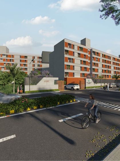 This street-level view shows how the community housing project integrates with its urban context. Landscaping at the perimeter helps soften the building's edge and creates a welcoming entrance for residents and visitors.