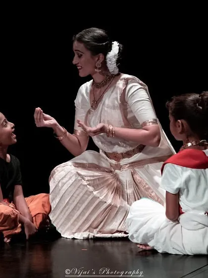 A candid moment of teaching on stage. By creating a story about sharing sweets, I can guide the children to express joy and anticipation naturally.