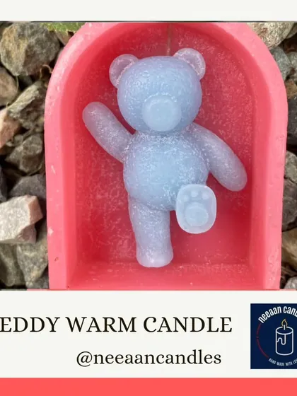 Warm hugs and cozy vibes. This teddy warm candle features a blue teddy bear in a pink archway, a truly adorable piece.