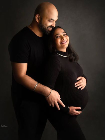 A sleek and modern couple's portrait. Dressed in all black, these parents-to-be create a powerful and timeless image of their journey together.