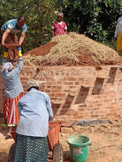 Our team working on a brick structure, mixing mud and straw. This hands-on process is part of our mission to equip women with skills in sustainable building practices.