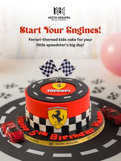 Fulfilling a little speedster's dream with this sleek, Ferrari-themed cake. The design features the iconic red, checkered flags, and the famous logo, making it the perfect highlight for a racing-themed party.