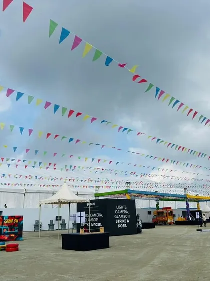 An open activity area at the Ola factory event, decorated with colorful bunting. I design flexible spaces that can be used for games, seating, or other interactive experiences.