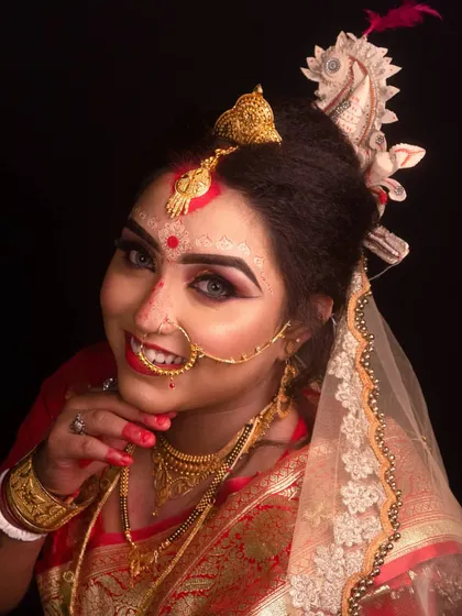 A beautiful portrait of a traditional Bengali bride. We have experience capturing the unique details of various Indian cultures, including the distinctive 'mukut' and intricate makeup of a Bengali wedding.