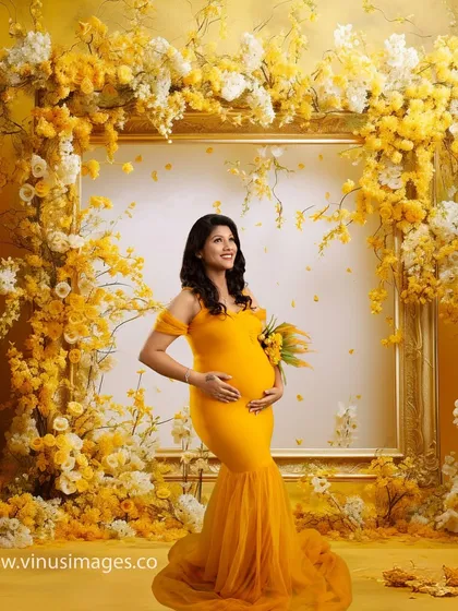 A stunning portrait framed by an explosion of yellow and white flowers. The mother-to-be looks up with a hopeful expression, her yellow gown perfectly complementing the vibrant floral arrangement.
