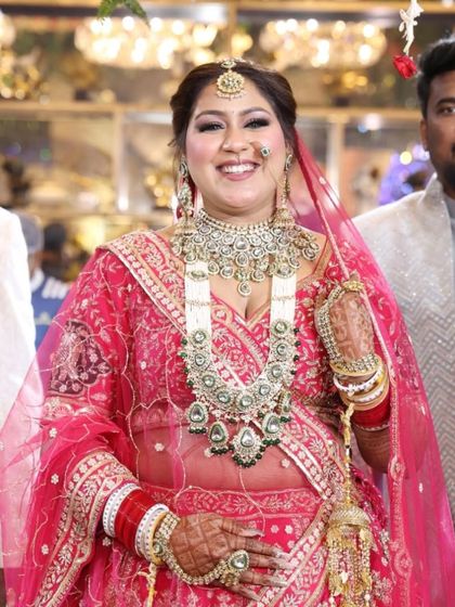 The bride with her groom. Her radiant smile is the best accessory, and the makeup is there to make it shine even brighter.