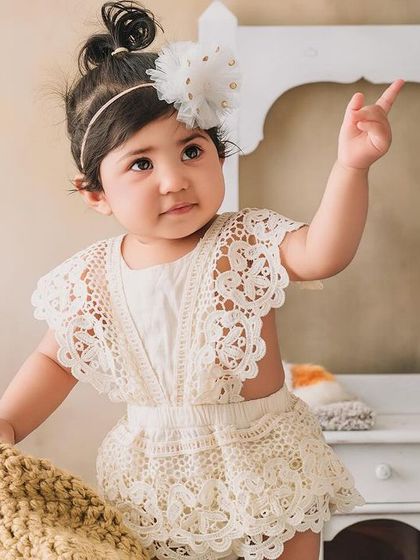 A curious glance from this little girl, pointing up at something that has caught her eye during her photoshoot.