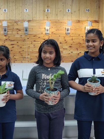 Our youngest participants holding their plant gifts. We believe in making our events memorable for everyone.
