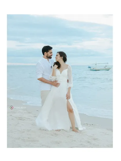 A serene and romantic moment on the beaches of Thailand. The soft, natural light and the gentle sea create a peaceful atmosphere, perfect for capturing the quiet connection between the couple.