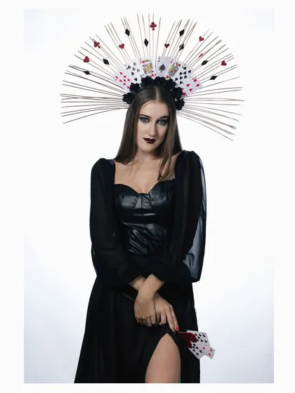 A full-length view of the "Queen of Cards" concept, showcasing the entire dark gown and the unique card-themed wand.