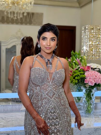 This image showcases the full reception look, with a focus on the sparkling gown and the complementary glamorous makeup.