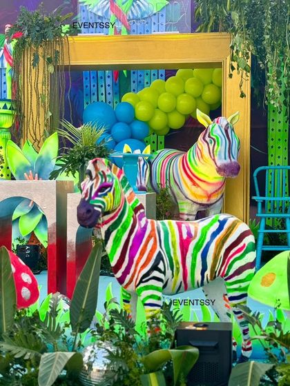Zebras get a rainbow makeover in this colorful jungle theme, surrounded by lush greenery and glowing mushrooms.