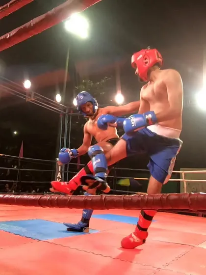 Divyam Agarwal lands a clean kick during his tough K1 category fight, earning a bronze medal.