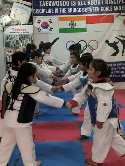 Students in full protective gear practicing their one-step sparring. This drill teaches distance management and reaction time.