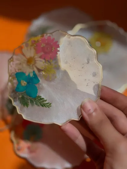 A simple yet colorful coaster made with a variety of pressed flowers. These are perfect for adding a pop of color to your table.