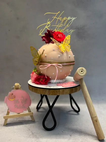 This is my bombshell piñata cake, a chocolate sphere that you get to smash open with a hammer. It's filled with chocolates and other surprises, making it a fun and interactive dessert for any party.
