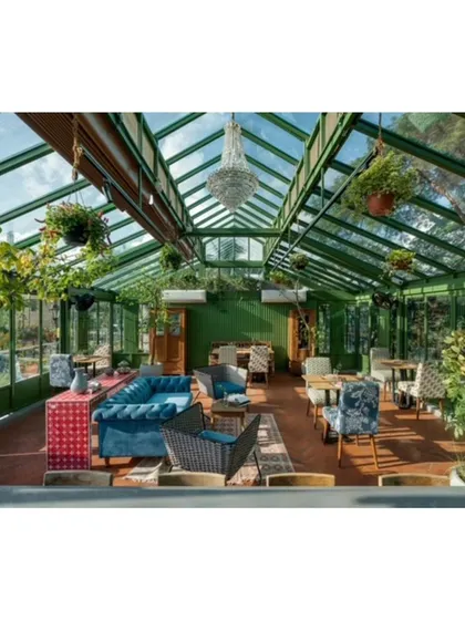This rooftop conservatory, designed as a culinary studio, is an urban oasis inspired by Victorian iron and glass structures. The space is filled with our custom and curated furniture, creating a light filled environment that blurs the line between indoors and out.