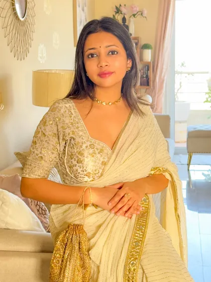 A direct look, showcasing the elegant sweetheart neckline of the brocade blouse paired with the simple, beautiful golden saree. A classic and timeless combination.