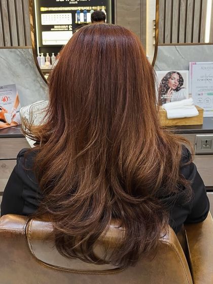A rich, warm brown global color with a healthy shine, styled with a simple blowout.
