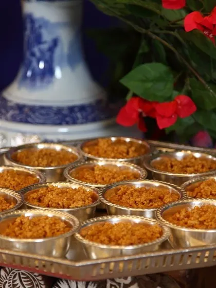 Individual servings of a traditional Rajasthani sweet, likely Moong Dal Halwa or Churma. The presentation in silver bowls highlights the richness of the dessert and our attention to detail.