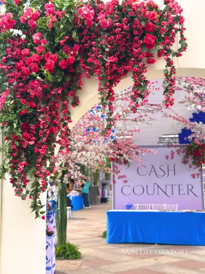 Even the cash counter can be beautiful. I framed this functional area with an arch of vibrant bougainvillea, ensuring that every single part of the event space is visually appealing.