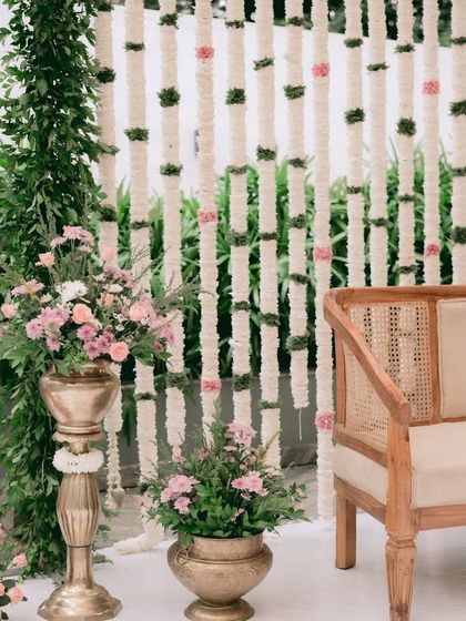 Another perspective on the minimalist engagement setup. The combination of natural textures like cane and brass with fresh greenery and flowers creates a refreshing and sophisticated look.