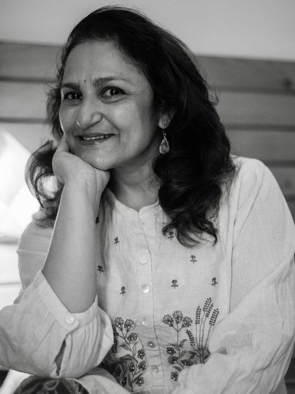 A simple, happy black and white portrait. The genuine smile and relaxed posture make this feel like a snapshot of a cherished memory.