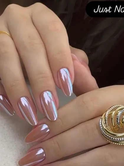 A chic and trendy look featuring a pearlescent chrome finish on medium-length almond nails. The color shifts beautifully in the light.