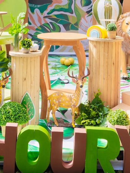 A detailed shot of the custom "SHOURYA" name blocks in bold green letters, placed in front of a table with deer and plant props.