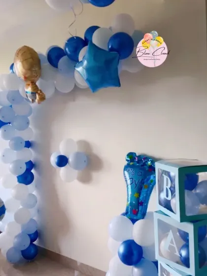 A blue and white balloon arch with 'BABY' blocks, perfect for a baby boy's welcome party or baby shower.