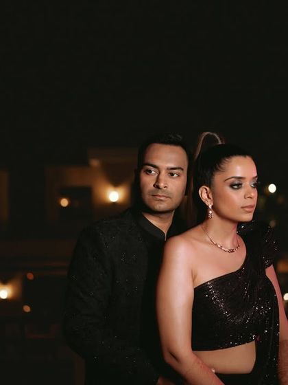 A stylish and moody portrait of the couple against the night sky, exuding elegance and glamour.