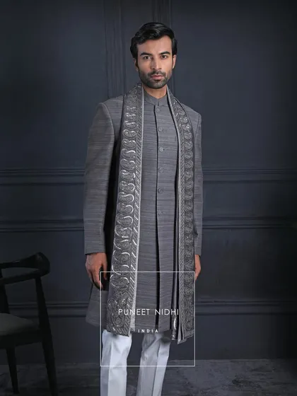 In the timeless elegance of charcoal grey Matka silk lies a story of India’s regal grace. The paisley-embroidered stole drapes like poetry, carrying centuries of tradition with a modern stride for the man who chooses heritage with dignity.