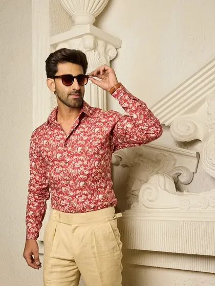 A different take on the red floral shirt, showing how it can be styled for a relaxed yet polished look. The vibrant print is both bold and sophisticated.
