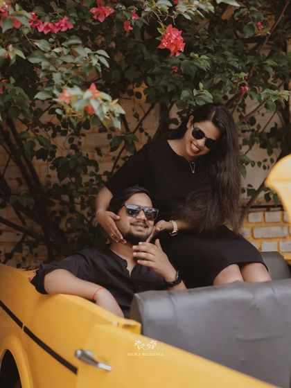 A playful moment with the couple in a vintage yellow convertible, enjoying their pre-wedding shoot.