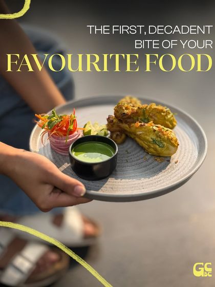 That first, decadent bite of your favorite food. Here, we're serving up a delicious appetizer with a fresh green chutney, perfectly plated and ready to enjoy.