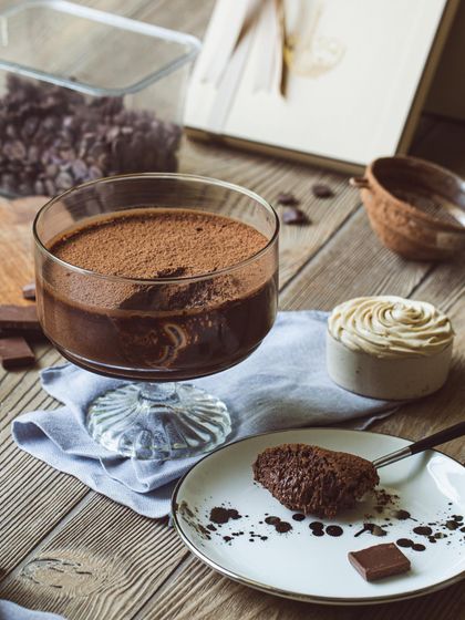 A moody shot of my dark chocolate mousse, served with a spoonful on a plate to show its thick, creamy consistency.