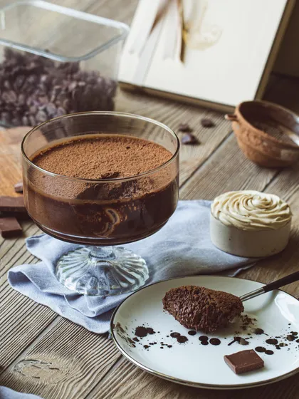 A moody shot of my dark chocolate mousse, served with a spoonful on a plate to show its thick, creamy consistency.