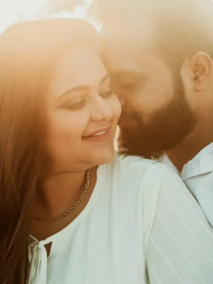 A close and affectionate portrait of a couple, filled with genuine smiles and warmth. This candid shot captures the easy, comfortable love they share.