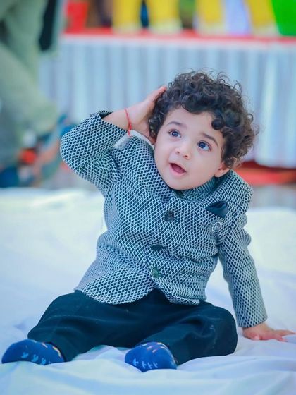 A playful moment in his formal best. The lightweight fabric and soft lining of our custom jackets mean he can move, play, and enjoy the celebration without any fuss.