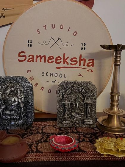 My embroidered logo displayed in the studio, surrounded by objects that inspire me. It's a reminder of my passion for this beautiful art form.