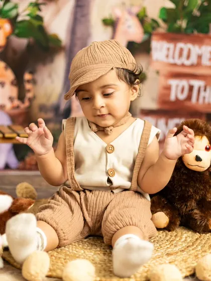 A quiet moment as our little explorer sits among his stuffed animal friends in the jungle.