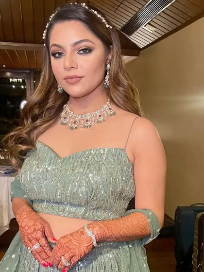 A beautiful half-updo with soft waves, accessorized with a pearl headband for a sophisticated look.