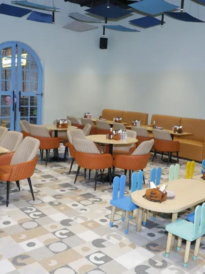 Another view of our clean and modern dining area, with a mix of colorful kid's chairs and stylish seating for parents.