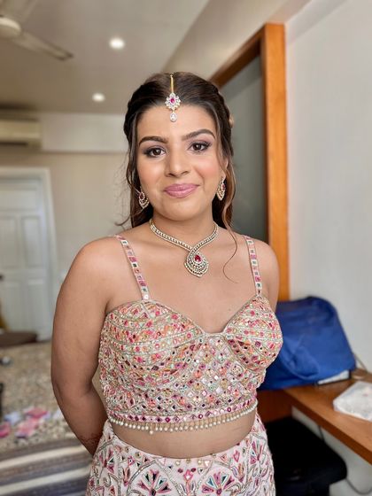 A happy and confident bride-to-be. The makeup is fresh and glowing, enhancing her youthful features for her engagement or pre-wedding party.