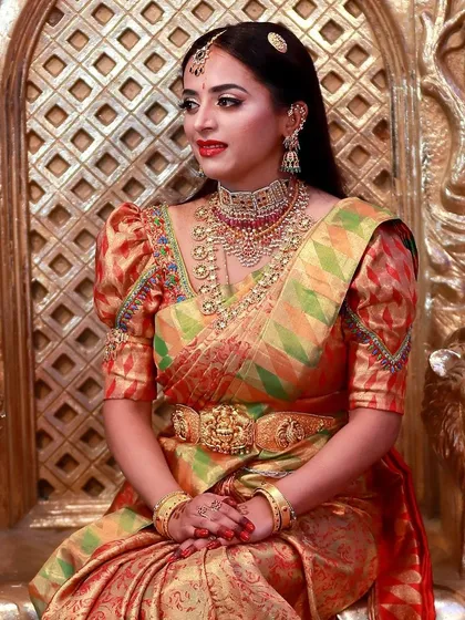 The side profile of Lakshmishri's royal look, showcasing her intricate jewellery and the clean, straight hairstyle we chose for her.