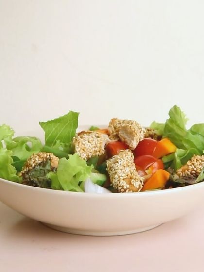My Orange and Sesame Chicken Salad is both light and flavorful. It features sesame-coated chicken on a bed of fresh lettuce with orange segments for a citrusy kick.