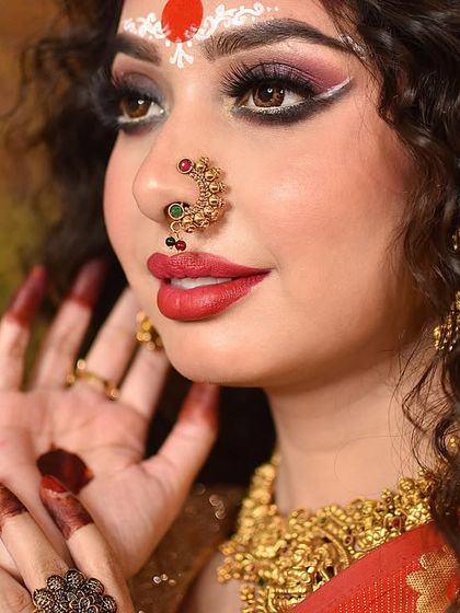 A close-up on the intricate makeup and jewelry, key elements of this traditional look.